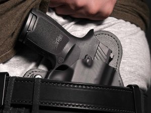 Man Drawing Firearm from Concealed Carry Holster