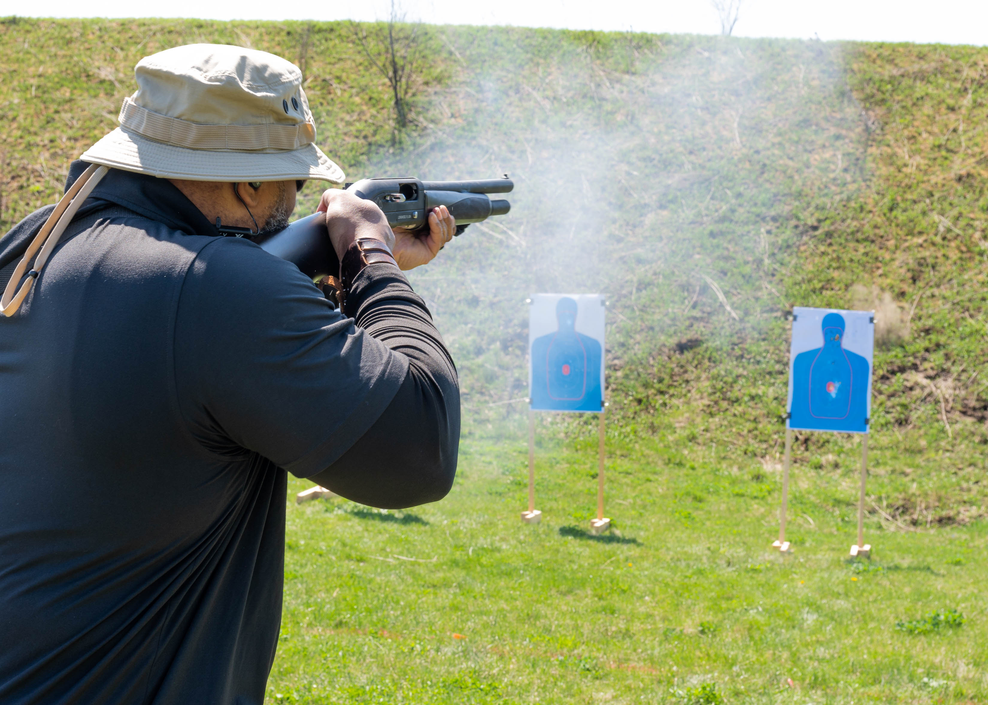 Student firing a shotgun in an outdoor Defensive Shotgun course.